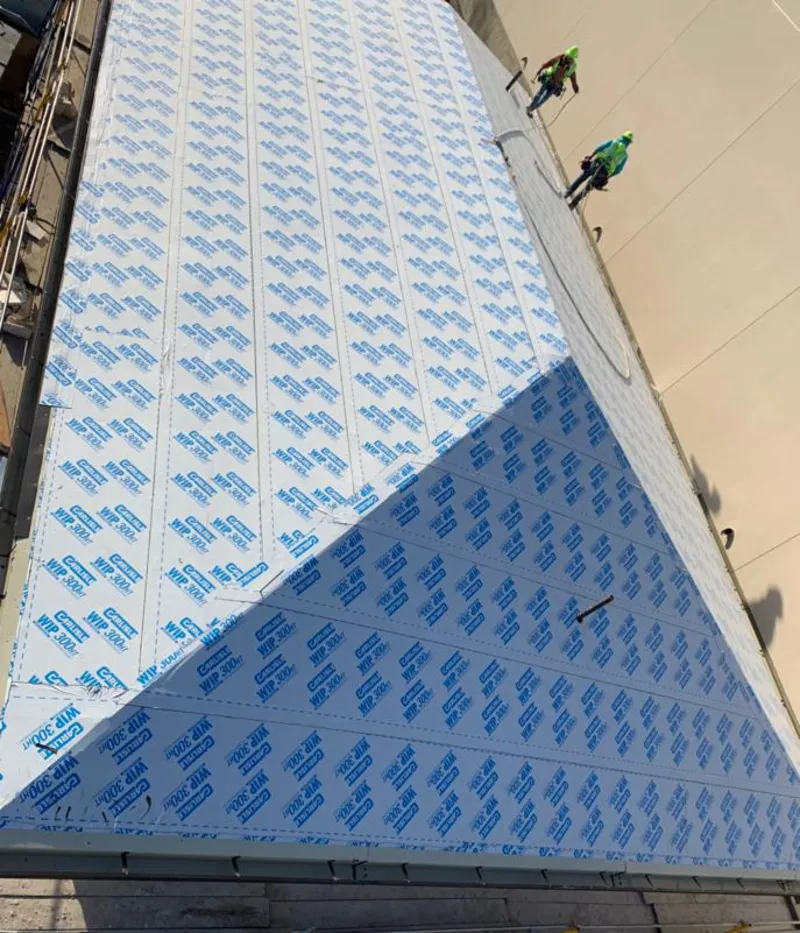 Professional roofers installing underlayment on a metal roof in Highgrove